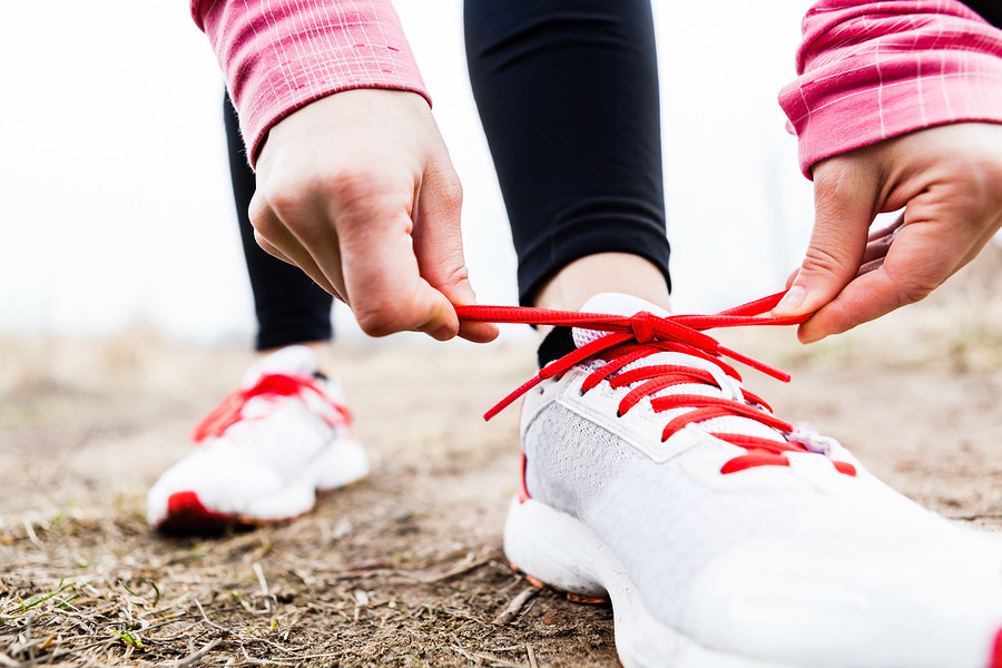 Woman-Runner-Tying-Sport-Shoes-52582435